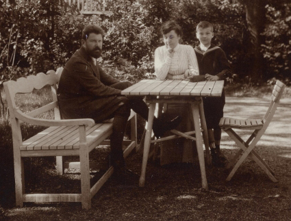 Details froma sepia photograph of Wilhelm and Grete Legler, with their son, Willi at a graden table (c. 1908)
